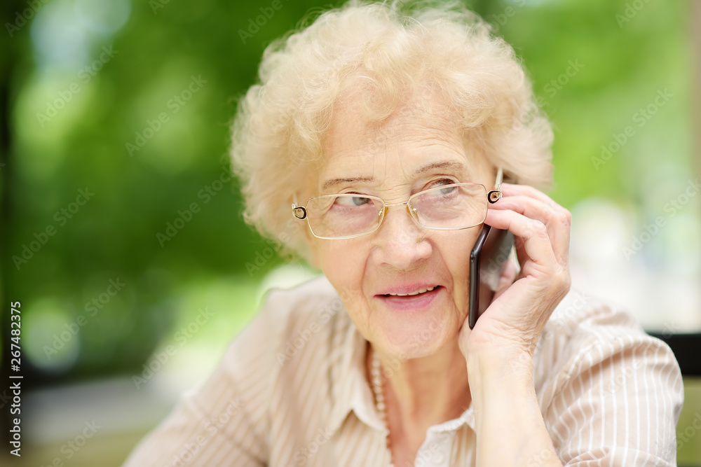 Beautiful senior lady with curly white hair talking on the phone. Communication, talk, gossip. Elderly lady lifestyles. Beautiful senior lady with curly white hair talking on the phone. Communication, talk, gossip. Elderly lady lifestyles.