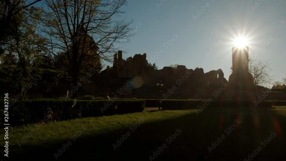 Wide angle view of the medieval Chindia Tower in the Transylvanian town of Targoviste featuring a beautiful sun flare Wide angle view of the medieval Chindia Tower in the Transylvanian town of Targoviste featuring a beautiful sun flare
