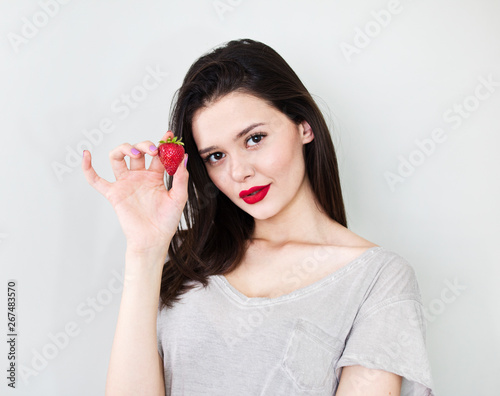 Portrait beautiful woman with strawberry over white background