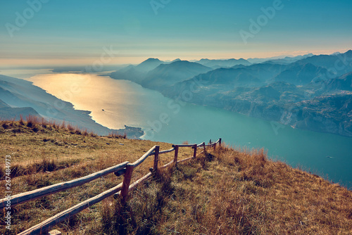 View of the Lake Garda from Monte Baldo, Italy.Panorama of the gorgeous Garda lake surrounded by mountains in the autumn photo