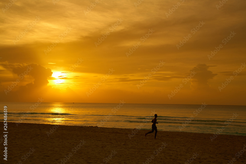 Beach with running athlete silhouette