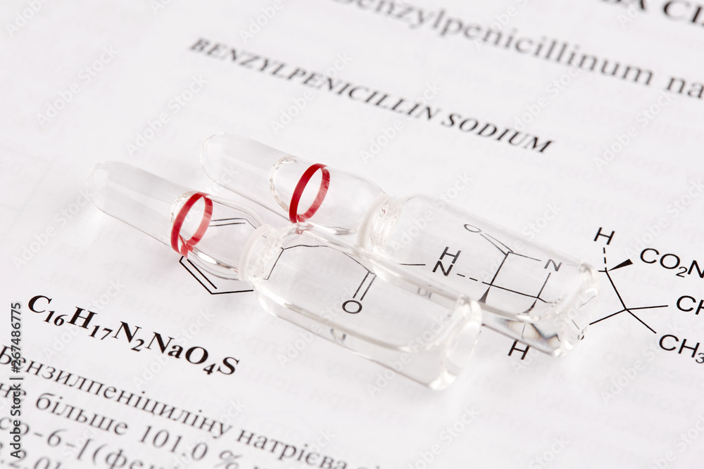 Two ampoules on book page with chemical formula Two ampoules on book page with chemical formula