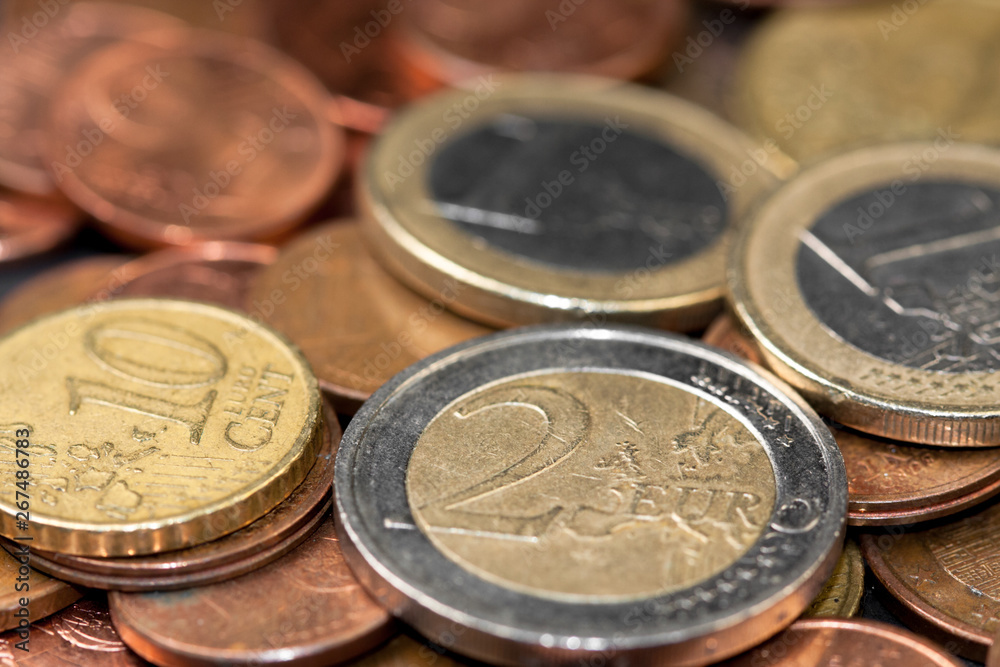 Different amounts of scattered European coins on a black background. Different amounts of scattered European coins on a black background.