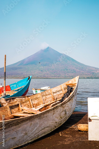 Boats in the lake shore in front momotombo volcano photo