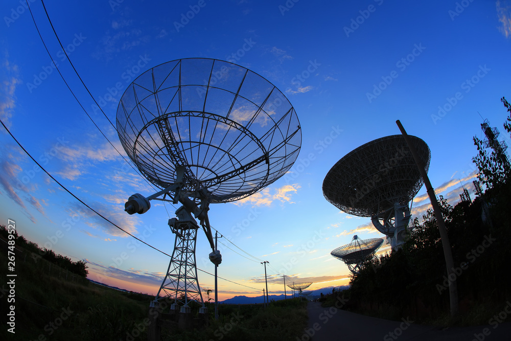 The silhouette of a radio telescope