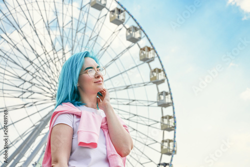 Portrait of young woman with blue hair