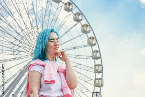 Portrait of young woman with blue hair