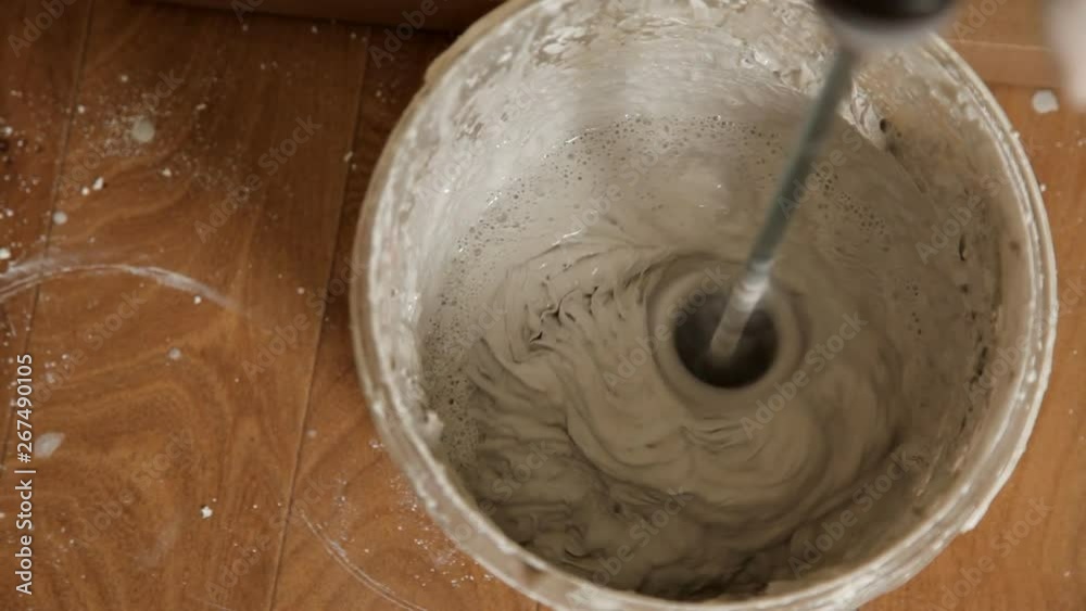 Cement mortar for tiles in the apartment. mixing cement mortar in a