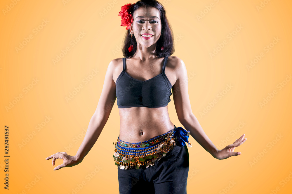Pretty belly dancer doing dance exercises on studio Pretty belly dancer doing dance exercises on studio