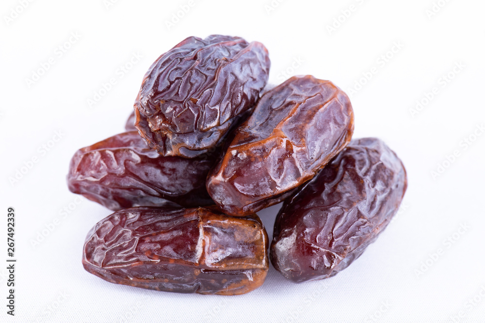 Ramadan food and drinks concept. Close up dates fruit on white background. Ramadan food and drinks concept. Close up dates fruit on white background.