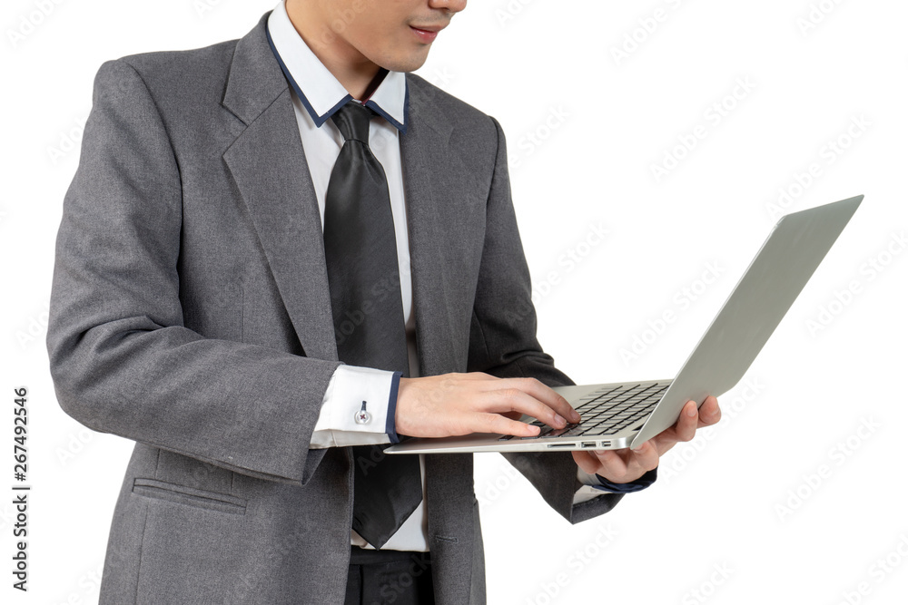Happy young businessman standing hold laptop in suit on white background, isolated concept Happy young businessman standing hold laptop in suit on white background, isolated concept