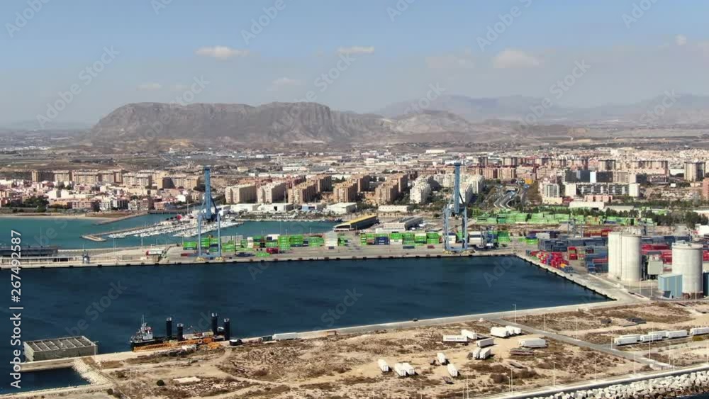 Drone orbiting left high over the port of Alicante, Spain gives a fantastic aerial view of the city and the mountains in the distance. Beautiful Mediterranean landscape and blue ocean. Drone orbiting left high over the port of Alicante, Spain gives a fantastic aerial view of the city and the mountains in the distance. Beautiful Mediterranean landscape and blue ocean.
