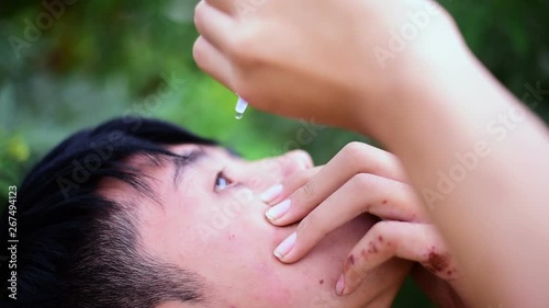 Boy dropping eye drop medicine healing his eye pain, health care eye medicine concept
