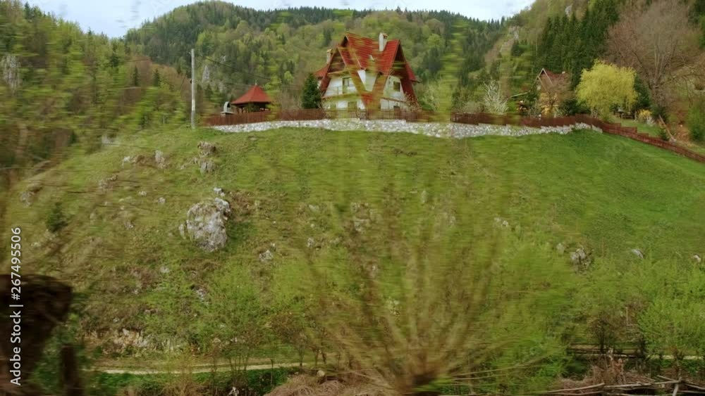 Tracking view of a wonderful pastoral scene in the heart of the Transylvanian mountains, with lush vegetation and quaint houses Tracking view of a wonderful pastoral scene in the heart of the Transylvanian mountains, with lush vegetation and quaint houses