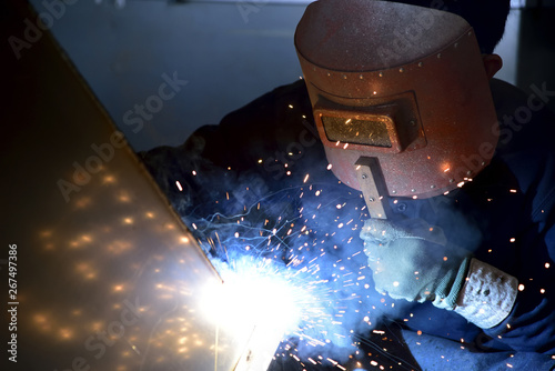 Arc welding work at a back street factory in Japan: Welding while protecting with handle welding mask
