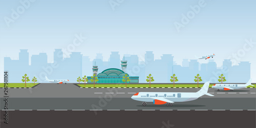 Airport building and airplanes on runway.
