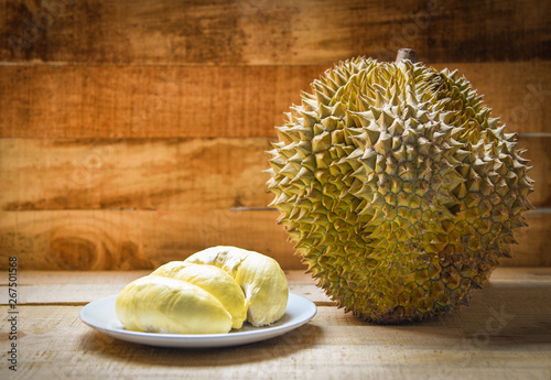 Durian riped on plate and durian fruit on wooden background on summer