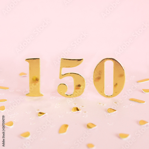 The number is 150 in golden numbers on a pink background and golden confetti. Space for text... photo