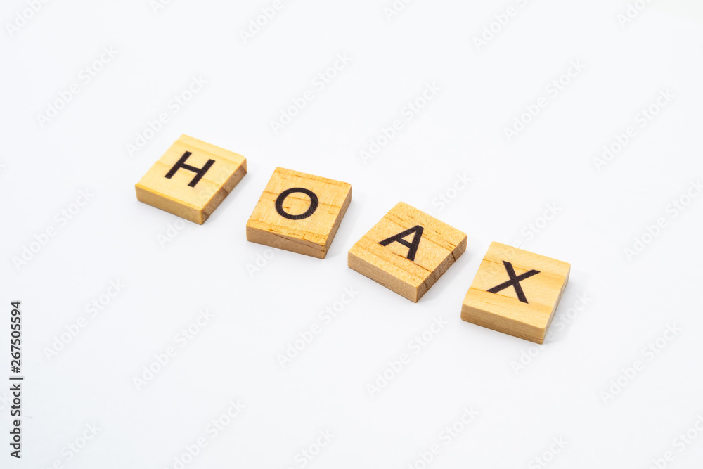HOAX word written in wooden blocks isolated on white background. HOAX word written in wooden blocks isolated on white background.