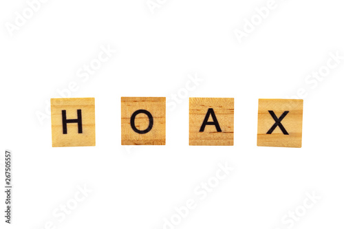 HOAX word written in wooden blocks on white background.