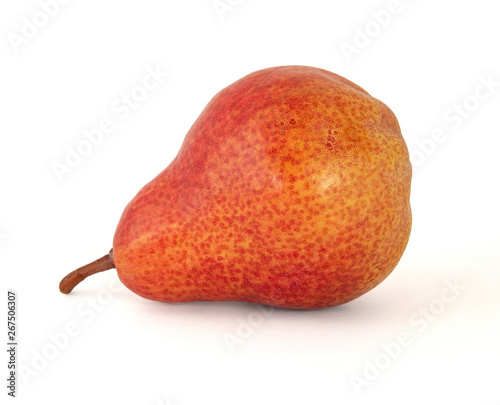 Appetizing fragrant yellow with bright red speckled pear with a brown twig on a white background