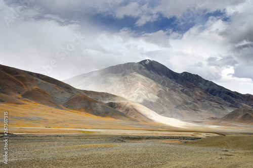 China, Tibet. Mountains near the lake Ngangla Ring Tso in cloudy weather in summer