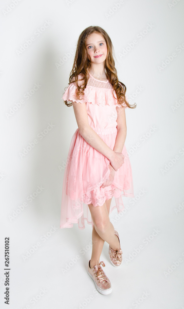 Portrait of adorable smiling little girl child in princess dress with curl hair standing isolated Portrait of adorable smiling little girl child in princess dress with curl hair standing isolated