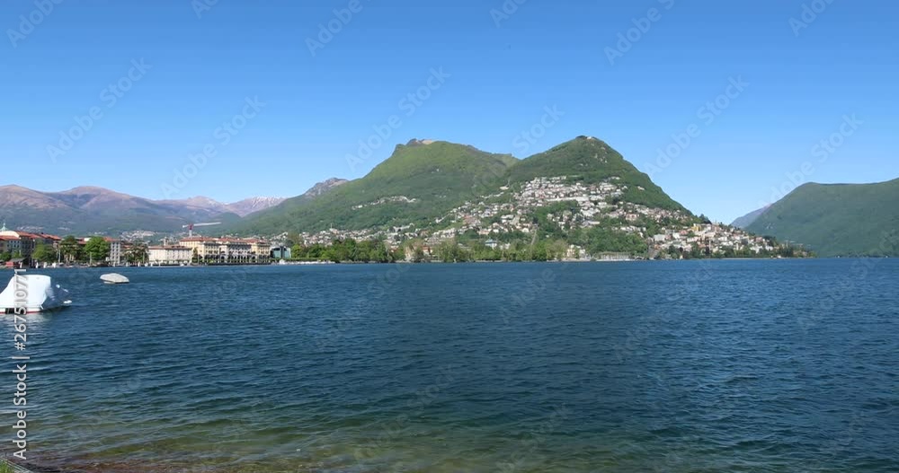 Panning shot of the beautiful coastline in Lugano, Switzerland during a sunny day. 4k resolution Panning shot of the beautiful coastline in Lugano, Switzerland during a sunny day. 4k resolution