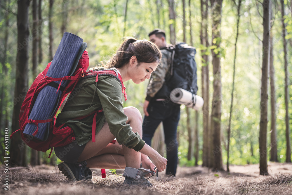 Fototapeta premium Young asian people hiking in the forest during summer at sunset,travel,tourism and teamwork concept.