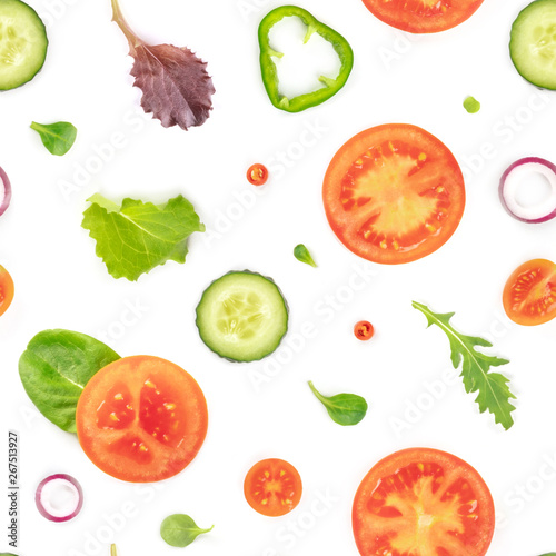 Fototapeta Naklejka Na Ścianę i Meble -  A seamless pattern of fresh vegetables and salad leaves. Tomato, cucumber, onion and pepper slices with mezclun on a white background, a vegan repeat print