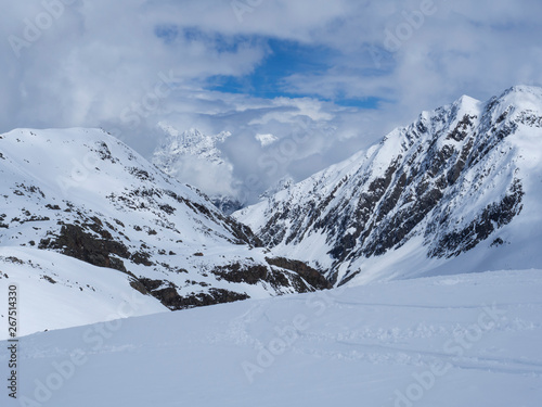View on winter mountain landscape at Stubai Gletscher ski area with snow covered peaks at spring sunny day. Blue sky background. Stubaital, Tyrol, Austrian Alps
