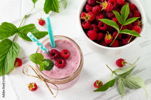 Raspberry fruit Yogurt smoothie or milk shake in glass jar on a wooden table. Natural detox, fruit dessert, healthy dieting concept.