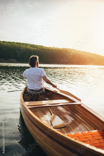 Canoeist paddling the wooden boat © yossarian6