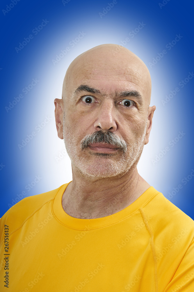 Obraz premium Portrait of a Bald, Mature Man with Big Eyes Looking at Camera.