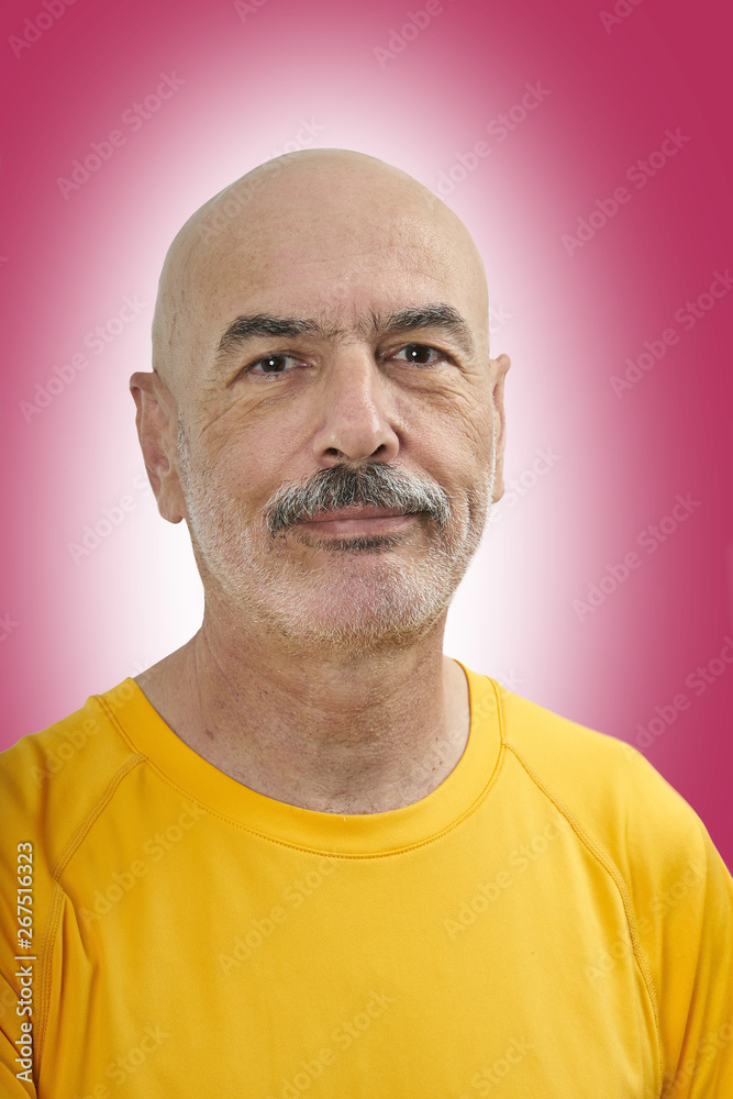 Obraz premium Portrait of Handsome Bald Mature Man on Color Background