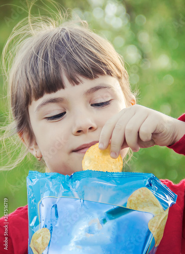 child eats chips. selective focus. food and drink. photo