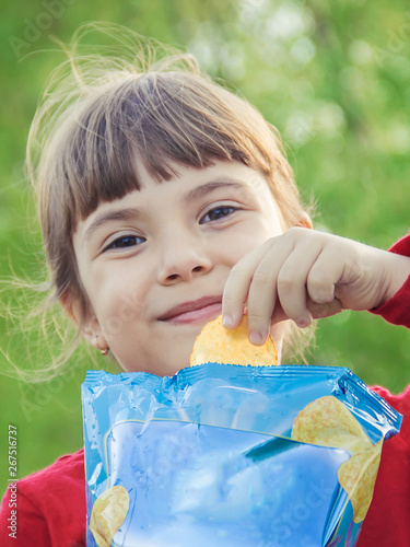 child eats chips. selective focus. food and drink. photo