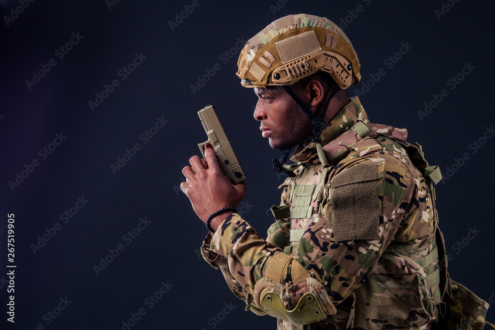american man in camouflage suit aiming with a pistol american man in camouflage suit aiming with a pistol