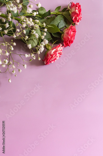 postcard with copy space bouquet of roses with small white flowers on purple background