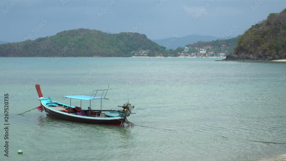 View off the Coast of Phuket Thailand, Thai long tail boats in the Sea on Tropical Beach View off the Coast of Phuket Thailand, Thai long tail boats in the Sea on Tropical Beach