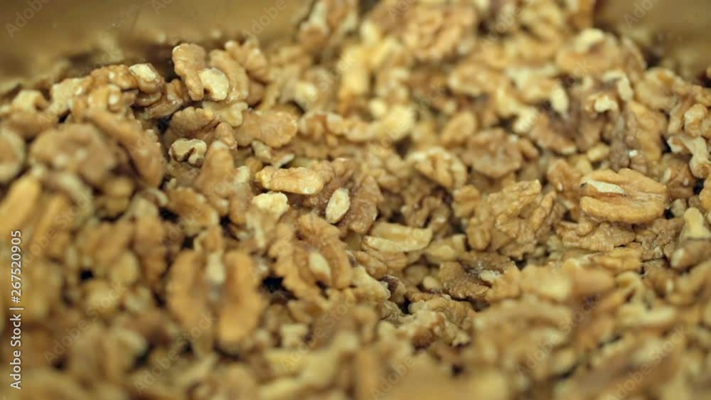 closeup of california walnuts in a metal bowl closeup of california walnuts in a metal bowl