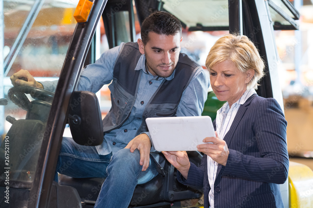 woman working with a forklift in a warehouse woman working with a forklift in a warehouse