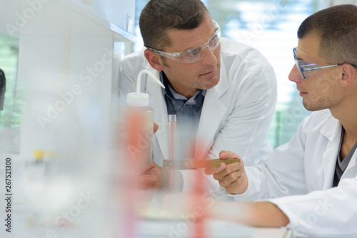 scientist discussing results of experiment with male colleague