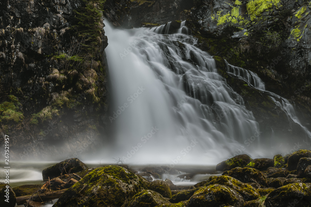 massive waterfall with rocks in the front covered with moss massive waterfall with rocks in the front covered with moss