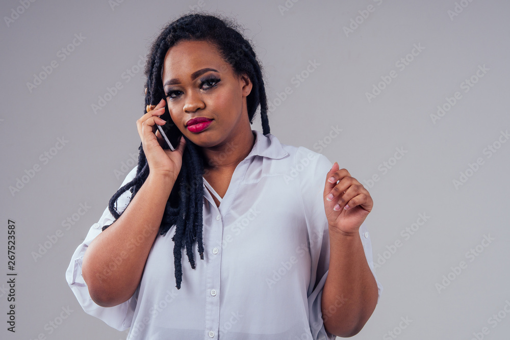 africa american woman with long black pigtails dreadlocks in studio on white background africa american woman with long black pigtails dreadlocks in studio on white background