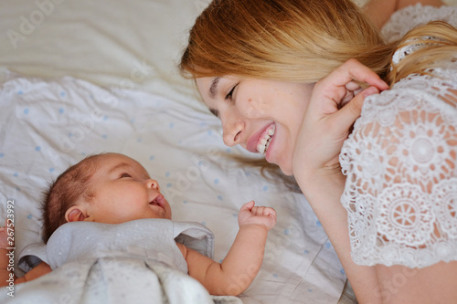 Young beautiful mother with her newborn baby girl