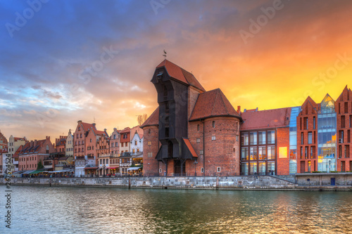 Old town of Gdansk with historic Port crane over Motlawa river at sunset, Poland.
