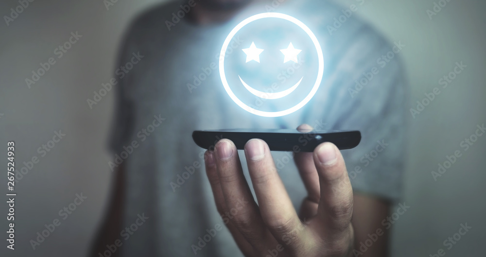Businessman holding happy icon. Customer experience concept Businessman holding happy icon. Customer experience concept