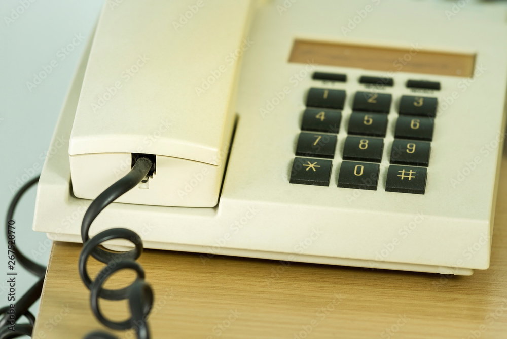 Close up in handset of classic landline telephone on wood background Close up in handset of classic landline telephone on wood background