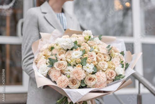 Large Beautiful bouquet of mixed flowers in woman hand. Pink and white color. the work of the florist at a flower shop. Delicate Pastel color. Fresh cut flower.